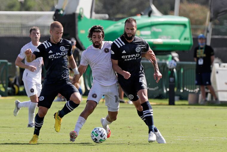 New York City FC defenders Anton Tinnerholm, left, and defender Maxime Chanot, right try to keep Inter Miami midfielder Rodolfo Pizarro, center, from getting to the ball during the first half.