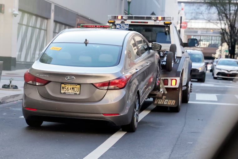 A Philadelphia Parking Authority (PPA) tow truck tows a vehicle from the 800 block of Filbert St. in Phila., Pa. on April 8, 2021.