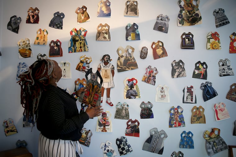 Vashti Dubois, founder, looks over the work of Janet Taylor Pickett inside The Colored Girls Museum.