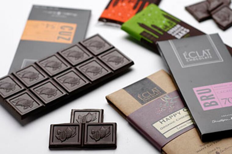 From Eclat Chocolate of West Chester, 70 percent cacao bars and, rear, Urban Garden Bars from John & Kira’s, the socially conscious North Philadelphia chocolatier. (MICHAEL S. WIRTZ / Staff Photographer)
