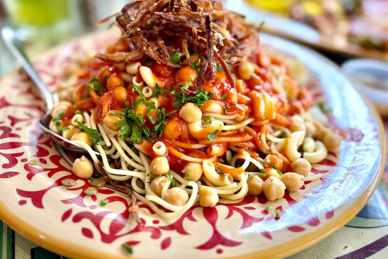 Koshary, a classic Egyptian dish that combines multiple shapes of pasta with rice, lentils, chickpeas, crunchy fried onions and spiced tomato sauce, at Cilantro Mediterranean Cuisine.