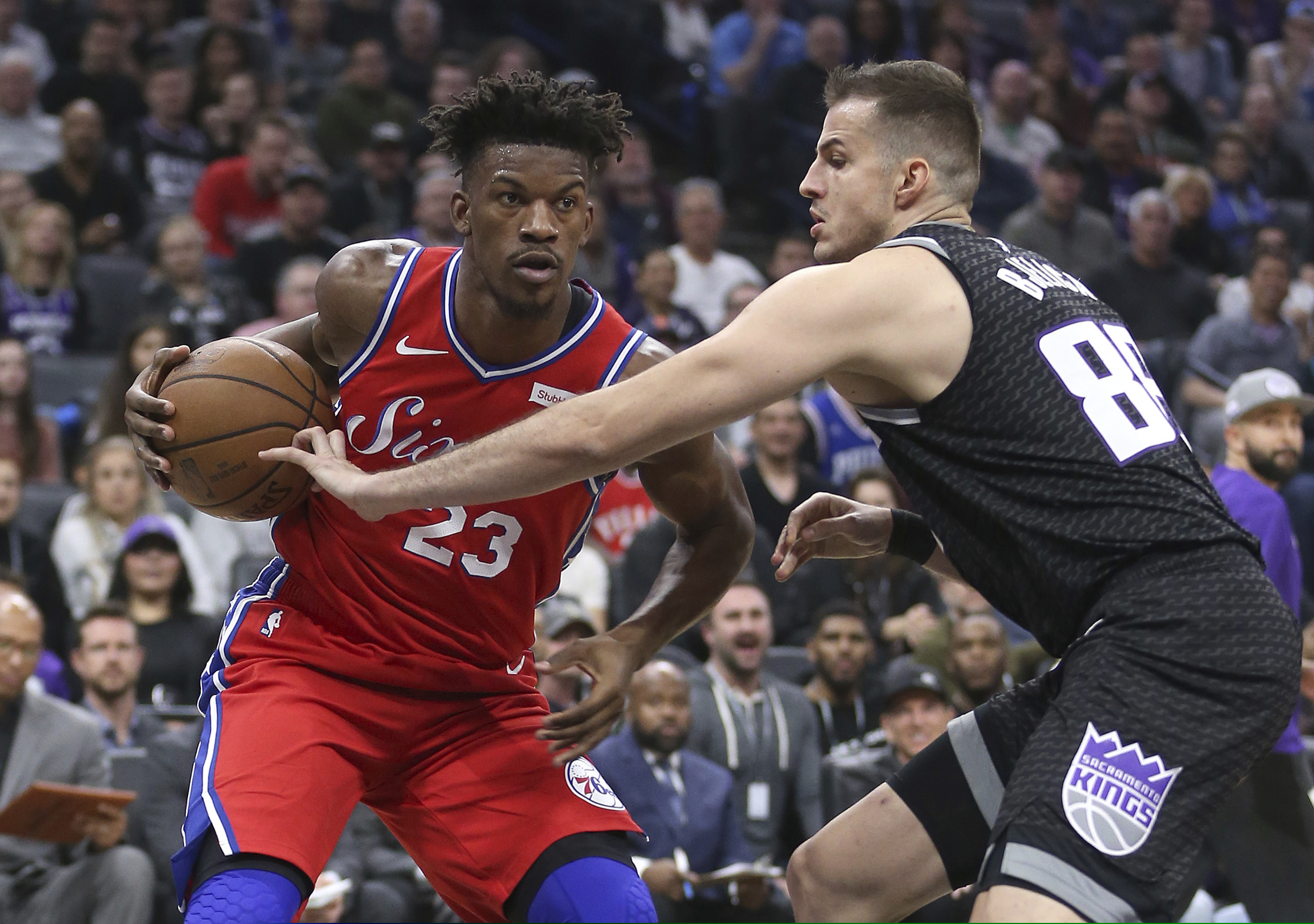Philadelphia 76ers guard Jimmy Butler, left, drives to the basket against Sacramento Kings forward Nemanja Bjelica during the first quarter of an NBA basketball game Saturday, Feb. 2, 2019, in Sacramento, Calif. (AP Photo/Rich Pedroncelli)