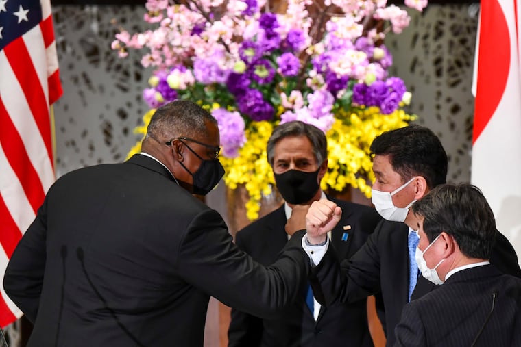 U.S. Defense Secretary Lloyd Austin (left) and Secretary of State Antony Blinken (second left) leave after their joint press conference with Japan's Foreign Minister Toshimitsu Motegi (right) and Defence Minister Nobuo Kishi (second right) after their 2+2 meeting at Iikura Guest House in Tokyo on Tuesday.