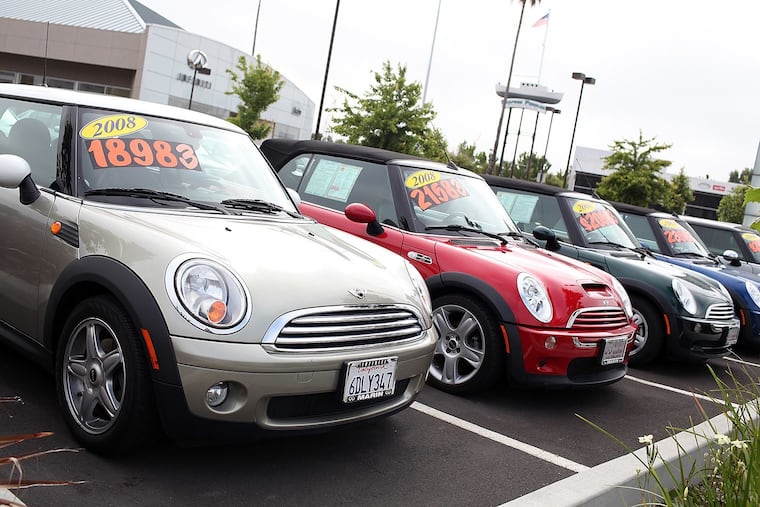 Used cars are displayed on a sales lot in June in San Rafael, California.