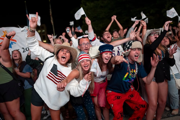 People celebrate while watching a live feed from Paris at the moment on Wednesday the International Olympic Committee awarded Salt Lake City the 2034 Winter Olympics.