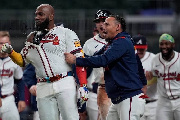 Marcell Ozuna (center) celebrates his walk-off two-run homer against the Phillies.