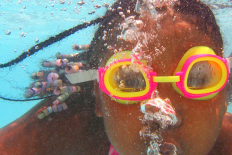 The pool at the Kingsessing rec center — here being enjoyed by Shannon Byrd a few summers ago — is one of the 46 out of 73 that will be open this summer. (File photo)