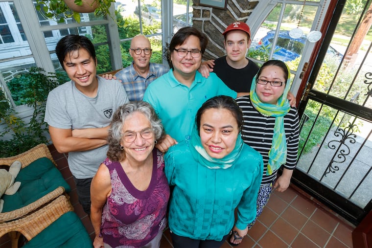 Hussain, center, is surrounded by his American "famliy" and three of his siblings from Afghanistan who now live in the United States. From top left clockwise, Afghani brother Ali; American father Kevin Peter; American brother Ben Peter; Afganis sisters Hawa and Husnia; and American mother Nancy Peter.