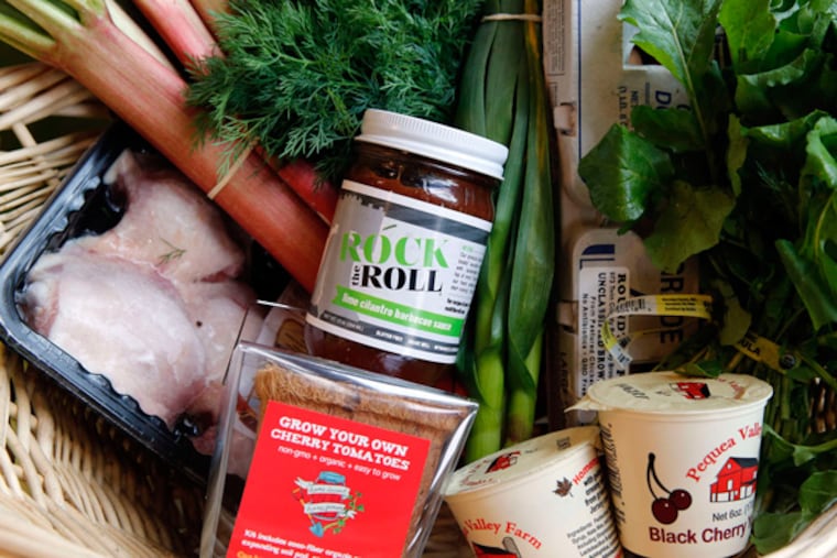 CSA food items from Green Aisle Grocery, including produce, poetry, eggs, yogurt, sauces and a kit to grow cherry tomatoes.