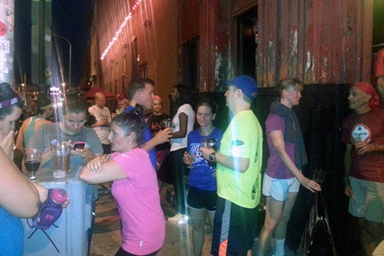 Fishtown Beer Runners stand outside Trestle Inn.
