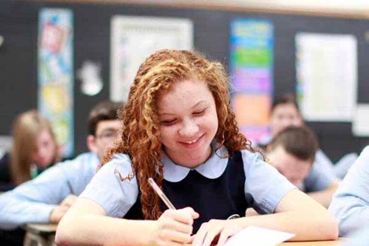 Ava Pizzaro, 13, and other 8th-graders from St. Charles Borromeo School school participate in the Caring Kids Christmas Card project Thursday December 12, 2013. ( DAVID SWANSON / Staff Photographer )