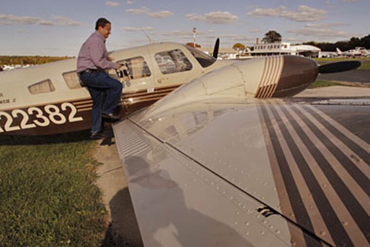 Paul DeSanctis, 39, climbs into the cockpit of his 1978 Piper Seneca that he is selling. (Jonathan Wilson / Staff Photographer)