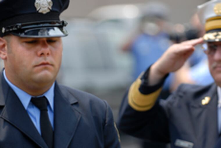 Tim Gallagher holds the helmet of his grandfather, Carl Hiller.