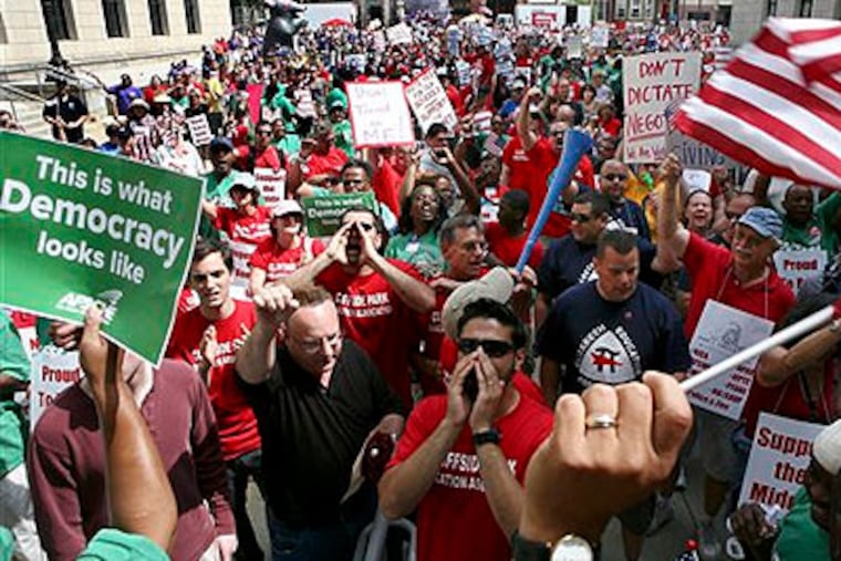 A large gathering of public employee union members and supporters protest Monday in Trenton, N.J., outside the Statehouse over plans by Gov. Chris Christie to reduce benefits and limit collective bargaining over health care for public workers. (AP Photo / Mel Evans)