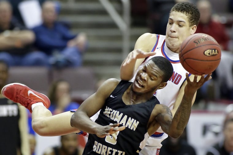 Neumann-Goretti’s Dymir Montague is tackled by Richland’s Tyler Zimmerman while going to shoot at the end of the 3rd quarter of the Neumann-Goretti vs Richland HS Boys Class 3A PIAA State Championship basketball game at the Giant Center in Hershey, Pa. on March 28, 2018. Montague scored 23 points and Neumann-Goretti wins the title.