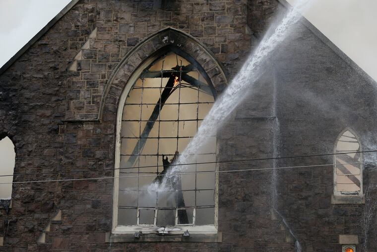 St. Leo the Great Roman Catholic Church in the Tacony neighborhood gets doused with water on Sunday, May 9, 2021. The historic church caught on fire Sunday afternoon.