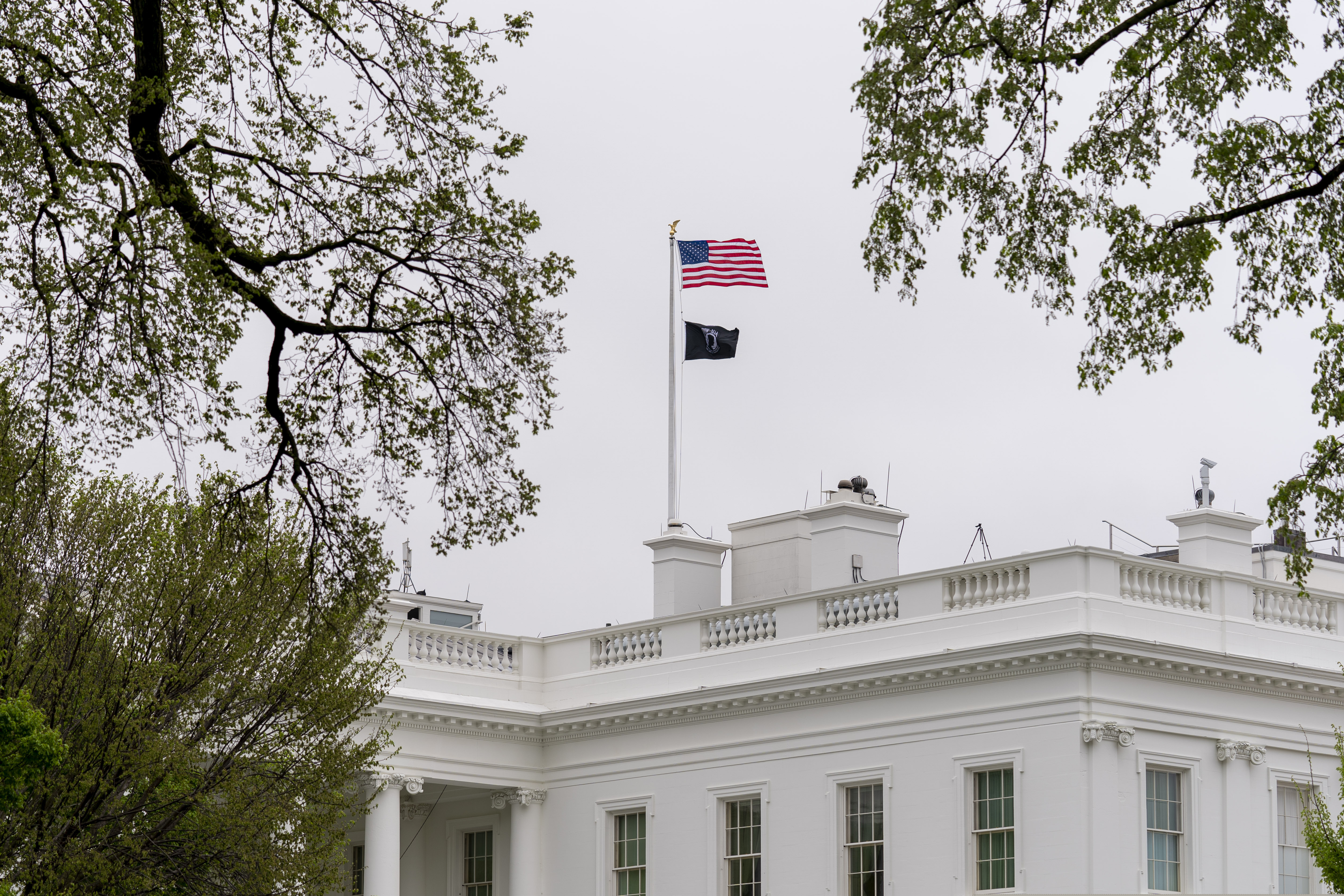 A POW/MIA flag flies along with the American flag above the White House on Friday.