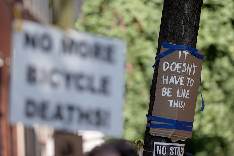 A couple signs on display during a vigil on the 1800 block of Spruce Street in Philadelphia, on Sunday, July 21, 2024. Philly Bike Action held the vigil for Barbara Friedes and other cyclists killed. Friedes, a CHOP resident, was killed while biking on Spruce Street earlier in the week.