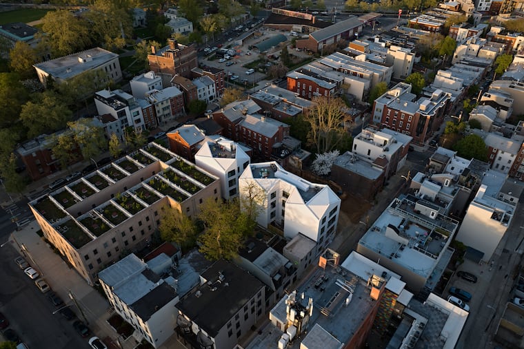LoDesign and developer Keith Alliotts were able to preserve an elegant, early 20th century brownstone on West Girard Avenue by taking advantages of a deep lot to create 12 condo units in the rear yard. By beveling the roofline and inserting light wells, the architects reduced the building's bulk.