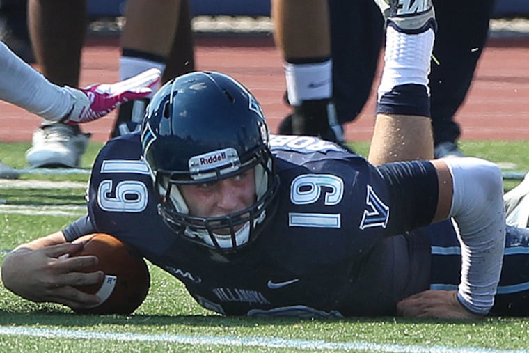 Villanova quarterback John Robertson is tackled while reaching for a first down. (Michael Bryant/Staff Photographer)