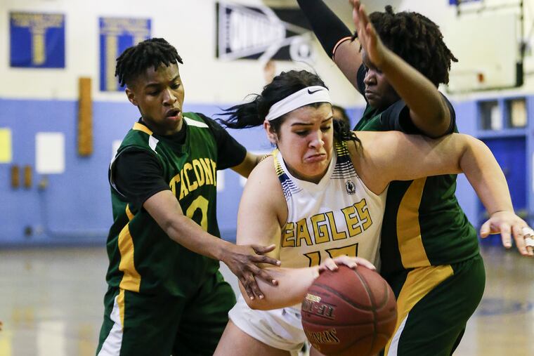 Washington's Isabella Vazquez drives between Tacony Charter's Michaela Flecher (left) and Amira Avery-Cheeks.