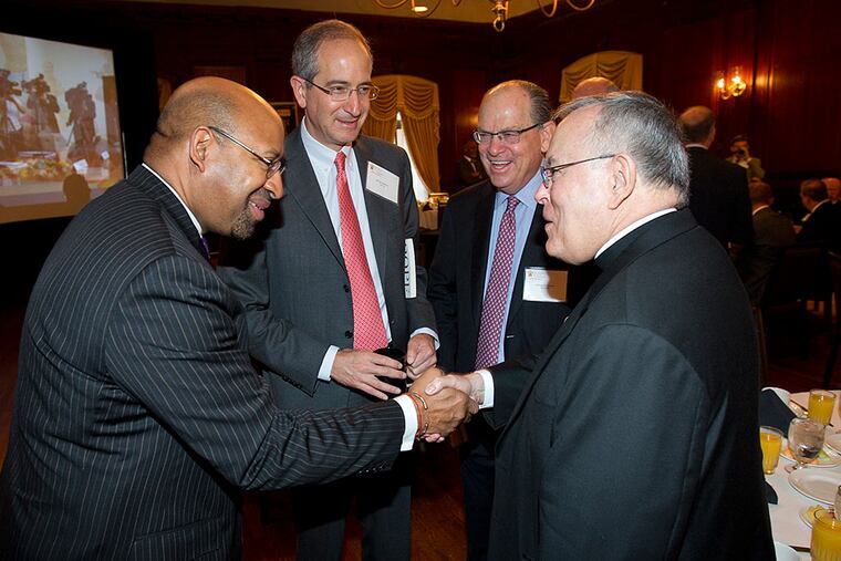 Mayor Nutter shakes hands with Archbishop Charles J. Chaput. With them were Brian Roberts (second from left), Comcast CEO, and Joseph Neubauer, Aramark chairman. ALEJANDRO A. ALVAREZ / Staff Photographer