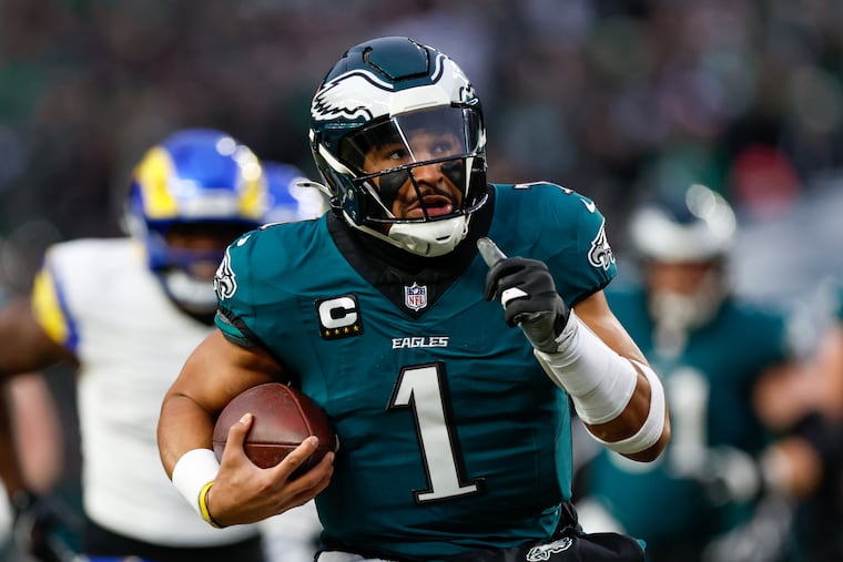 Eagles quarterback Jalen Hurts runs for a 44-yard touchdown during the first quarter against the Rams on Sunday. He had seven carries for 70 yards.