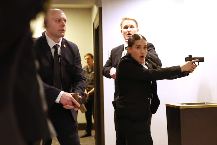 FILE - Secret service agents respond during the White House Correspondents Dinner, Saturday, April 25, 2026, in Washington.
