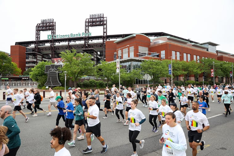 Runners pass Citizens Bank Park during the Eagles Autism Challenge event on Saturday.