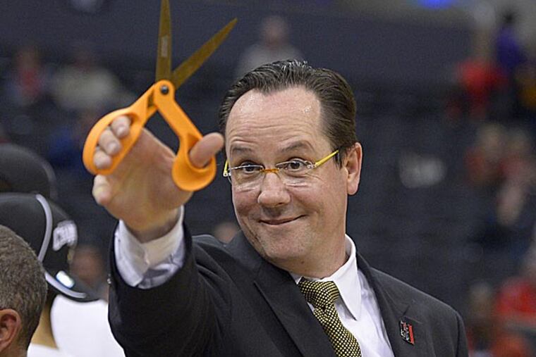 Wichita State coach Gregg Marshall holds up a pair of scissors after Wichita State defeated Ohio State. (Mark J. Terrill/AP)