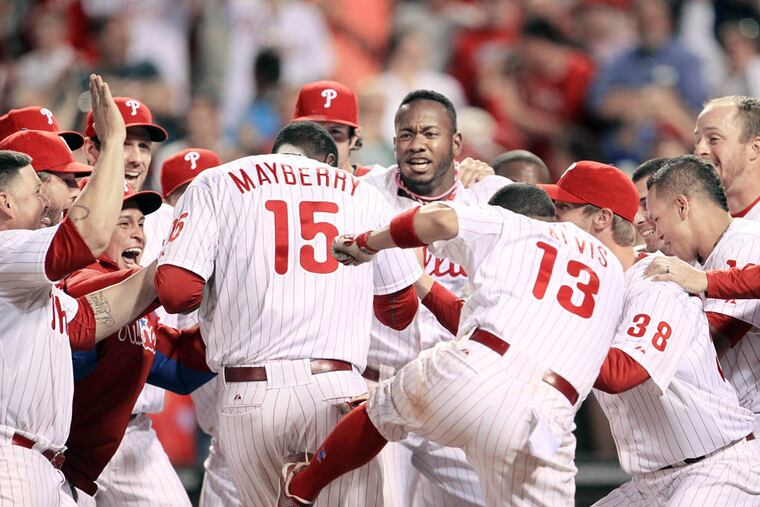 John Mayberry Jr., celebrates his game-winning, 11th-inning grand slam home run with his teammates Tuesday ( Yong Kim / Staff Photographer )