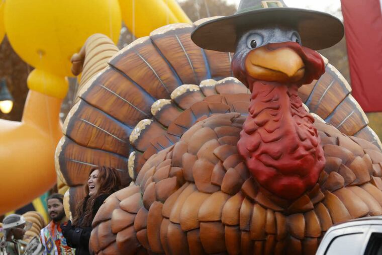 Country music artist Jo Dee Messina (bottom left) rides on a turkey float in the 97th annual Thanksgiving Day parade.