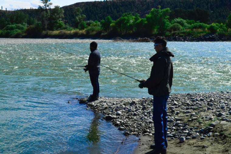 Shawn Lopez ,of Charleston, S.C., fishes with Eddie Lyons, of Fort Collins, Colo., at Yellowstone.