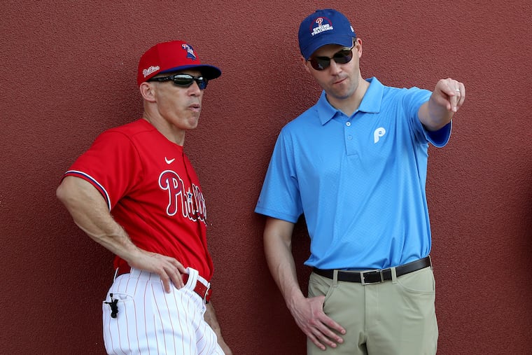 Phillies manager Joe Girardi, left, talks with general manager Matt Klentak during the Phillies' original spring training in Clearwater, Fla.