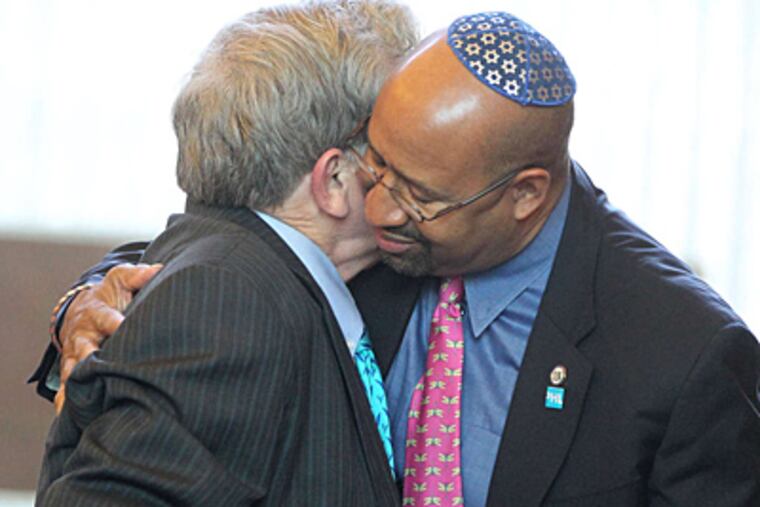 Mayor Nutter embraces Dick Fernandez during the service in Germantown. Nutter had served on City Council with Happy Fernande