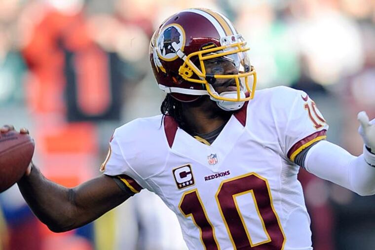 Washington Redskins' Robert Griffin III passes in the second half of
an NFL football game against the Philadelphia Eagles, Sunday, Dec. 23,
2012, in Philadelphia. Washington won 27-20. (AP Photo/Michael Perez)