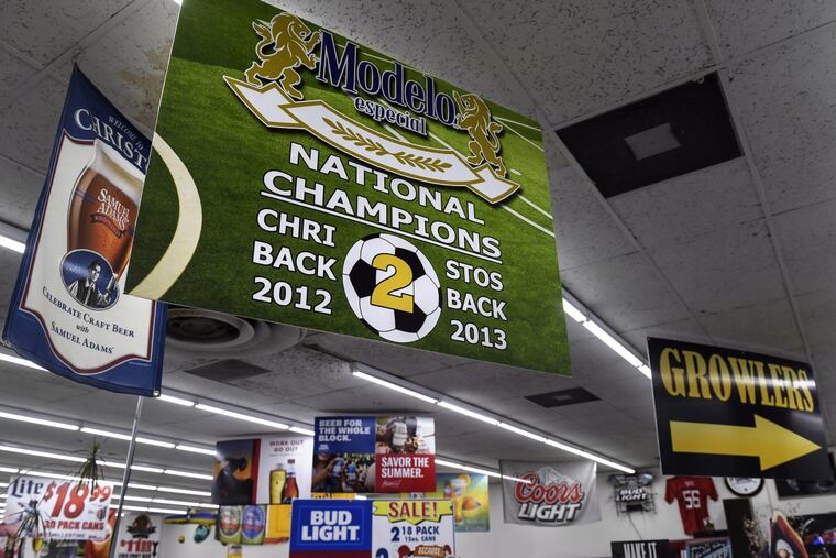 A sign honoring the Christos FC soccer team hangs in the liquor store that doubles as the team’s headquarters.