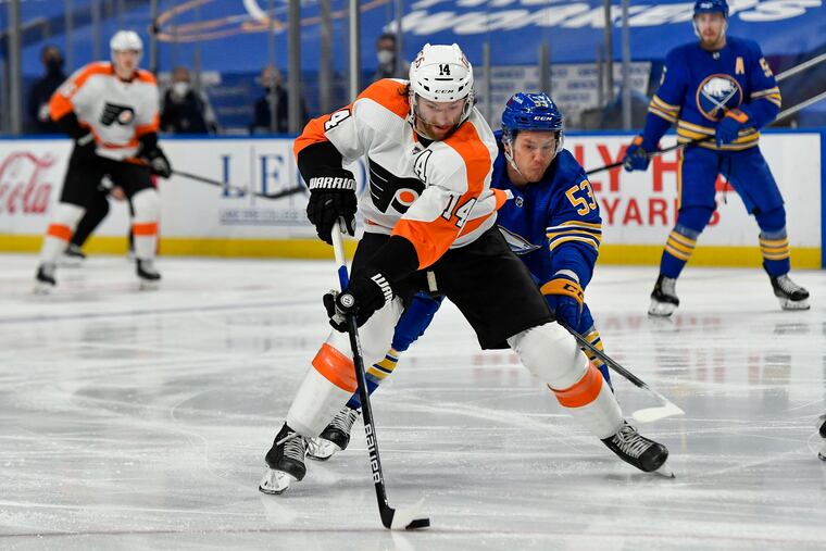 Flyers center Sean Couturier shields the puck from Buffalo Sabres left winger Jeff Skinner (53) during the first period Wednesday. Couturier set up Ivan Provorov's second-period goal to get the Flyers within 2-1.
