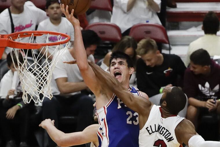 Sixers forward Ersan Ilyasova gets fouled by Heat guard Wayne Ellington during the Sixers’ win on Saturday.