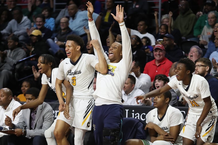 The Cheltenham bench including injured Zahree Harrison (center) celebrate in the final minute of their victory over Bensalem in the District 1 Class 6A semifinals at the Liacouras Center.