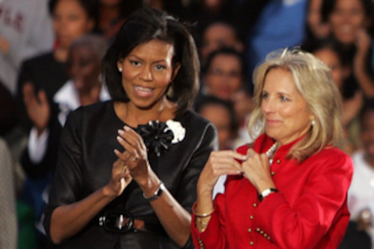 Michelle Obama (left) and Jill Biden drew about 3,000 to yesterday's rally.