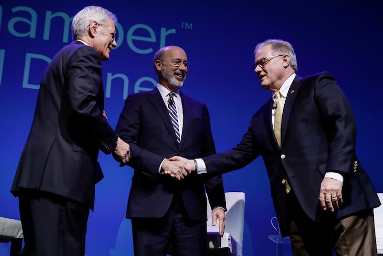 Democratic Gov. Tom Wolf, center, and Republican Scott Wagner, right, shake hands as moderator Alex Trebek looks on at a gubernatorial debate in Hershey, Pa., Monday, Oct. 1, 2018. The debate is hosted by the Pennsylvania Chamber of Business and Industry.
