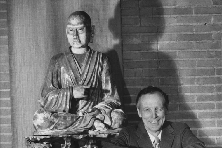 Robert H. Dyson next to the seated luohan in the museum's Asia Galleries in 1988.