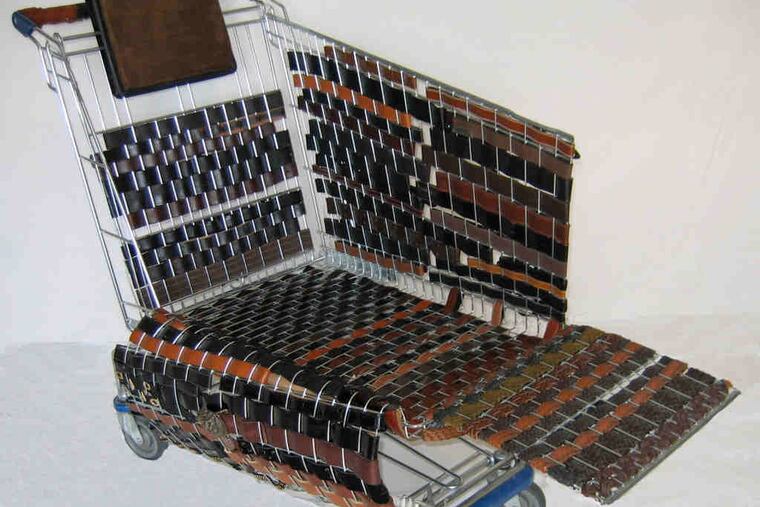 "Homelessnessvs. Hedonism," Deanna McLaughlin's sculpture incorporating a shopping cart, belts, and fabric, is part of "Dysfunctional Furniture," at City Hall through Feb. 25.