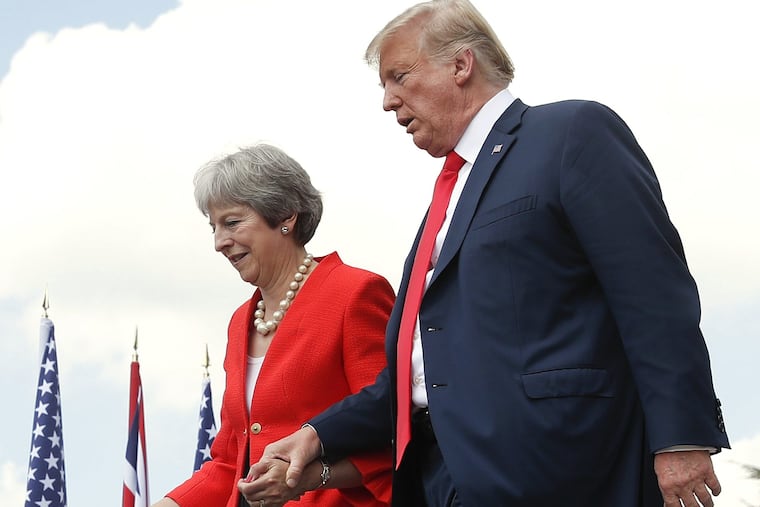 President Donald Trump and British Prime Minister Theresa May hold hands at the conclusion of their joint news conference at Chequers, in Buckinghamshire, England, Friday, July 13, 2018. (AP Photo/Pablo Martinez Monsivais)