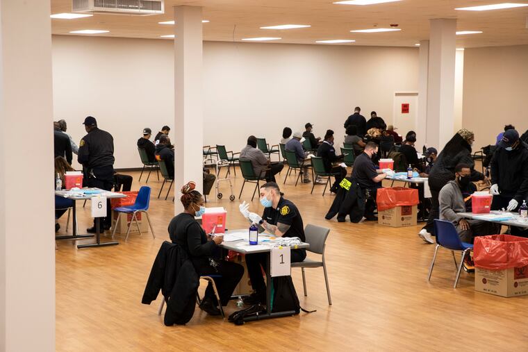 Philadelphia Fire Department paramedics administer vaccines during a neighborhood clinic in West Oak Lane in March.