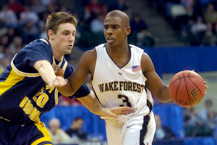 Former West Virginia standout and new Sixers president Mike Gansey (left) defends former Wake Forest star Chris Paul during a second round NCAA tournament matchup in 2005.