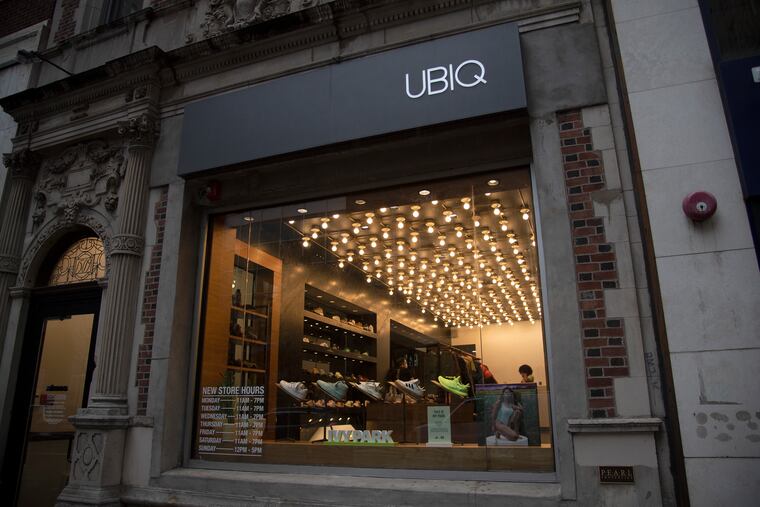 The UBIQ store on Walnut Street in Center City, with Atmos name on the front door at left, Nov. 11, 2020. UBIQ is merging with the international company Atmos to create Atmos USA.