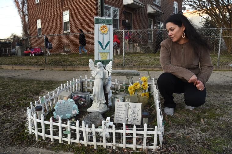 Angela Medina Trader with the memorial she maintains at the place in the Fairview neighborhood in Camden where her son, Troy Anderson, was shot and killed in 2014. She says she prefers it to his tombstone because it gives her a happy feeling. "It's a memorial to say he was here, he existed," says Trader.