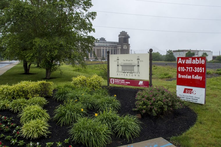 The corner of Highland Avenue and Seaport Drive in Chester with the renovated Delaware County Electric Co. building along the Delaware waterfront in the background.
